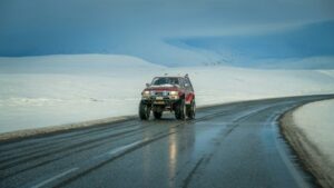 A four-wheel drive car driving in Iceland during winter