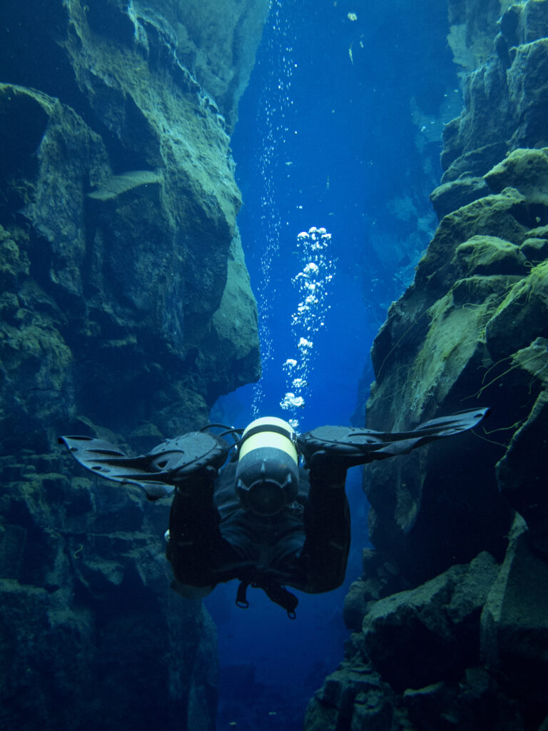 View from Directly Behind Scuba Diver at Continental Split at Silfra in Deep Section at Pingvellir National Park