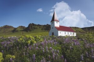 Vík church on the hill on a sunny summers day in Iceland