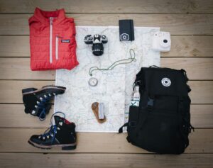 Packing a suitcase of clothing and equipment for a summer trip to Iceland