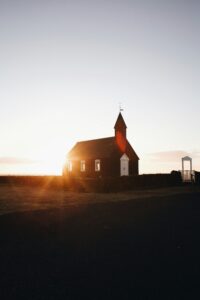 The Midnight Sun over the black church in Búðir