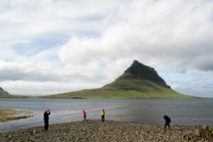 A family enjoying the sights of Kirkjufell mountain in Iceland