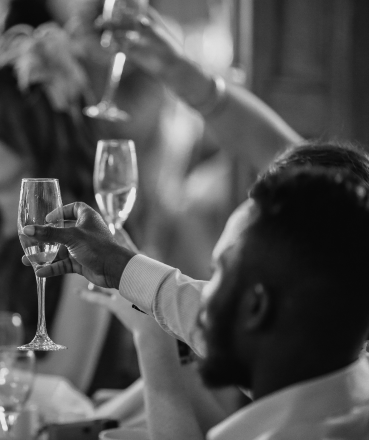 A group of people raising a celebratory glass of champagne at the Hill Hotel in Iceland