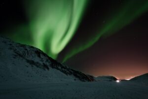 The Northern Lights in Iceland over a snow-covered moutain