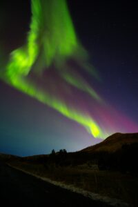 The Northern Lights dancing above the Icelandic countryside