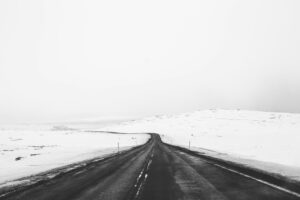 Snow-covered landscapes surrounding roads in Iceland during winter