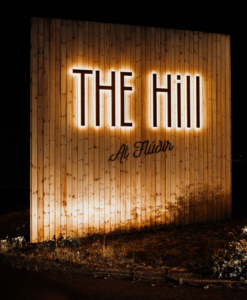 The Hill Hotel in Flúðir outside street sign at night