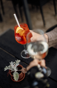 A couple at the Hill Hotel in Iceland toasting with cocktails at the bar during summer