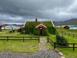 A turfhouse in Iceland under a cloudy sky